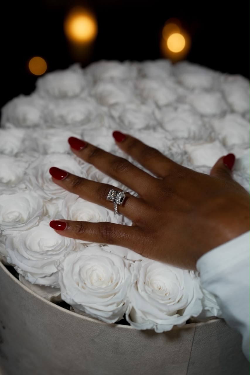 The engagement ring among white roses