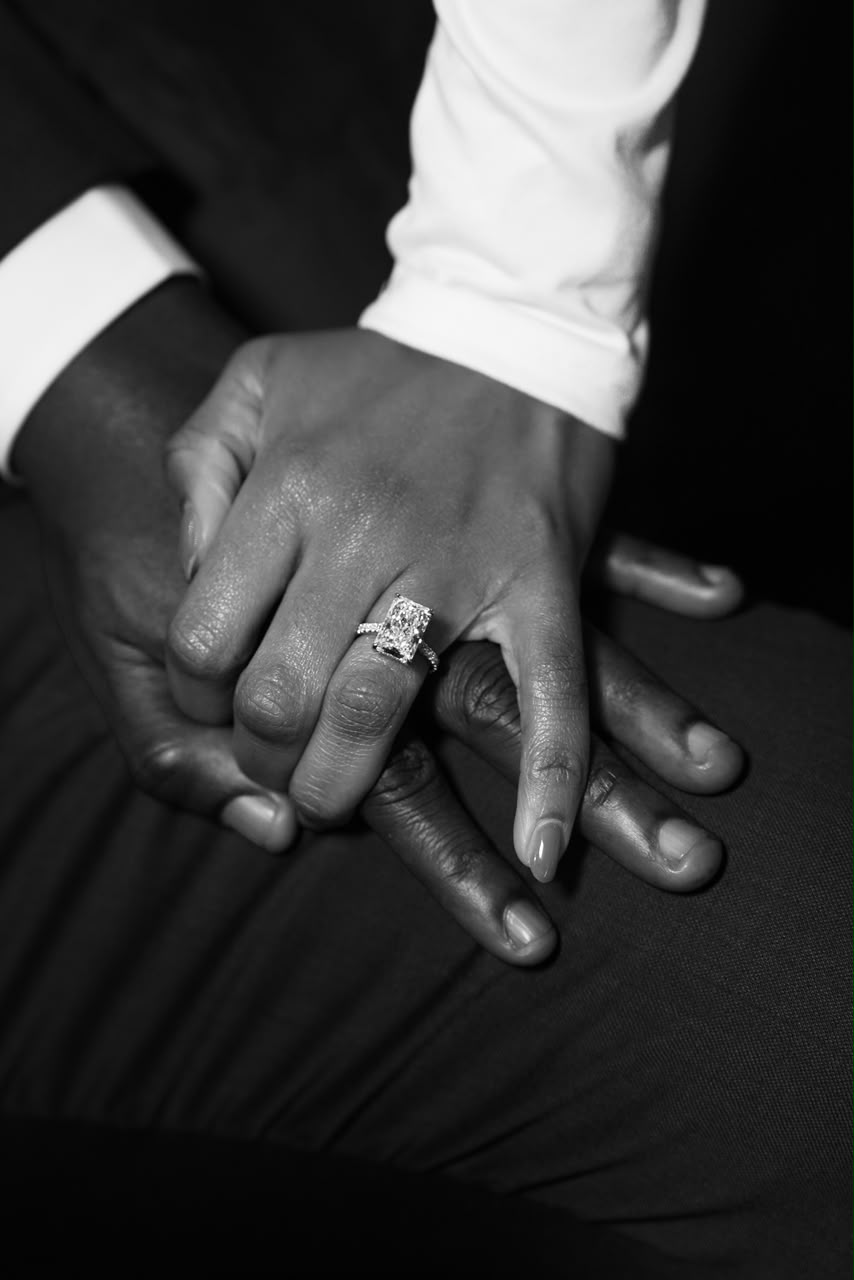Harrison and Otobong's hands in black and white