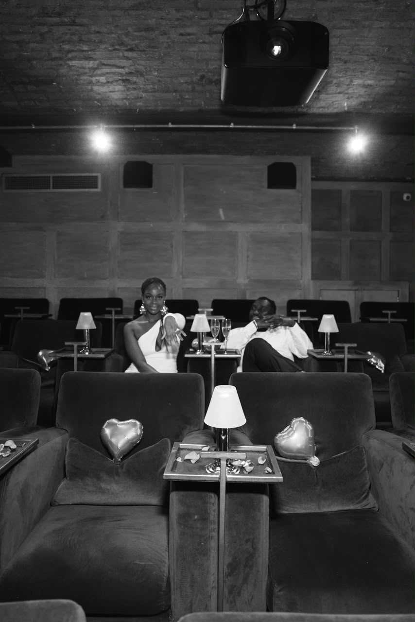 Harrison and Otobong seated together in black and white