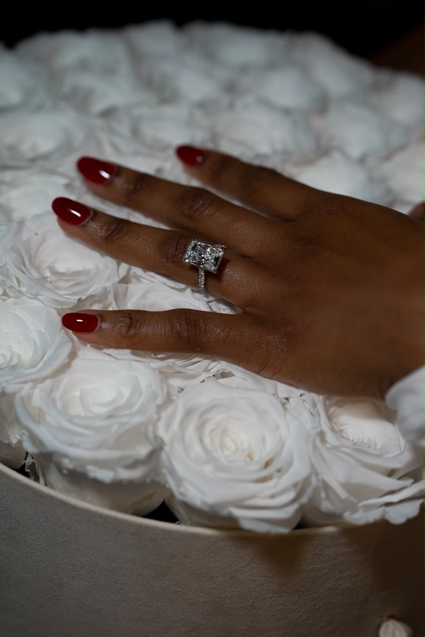 Otobong’s engagement ring among white roses