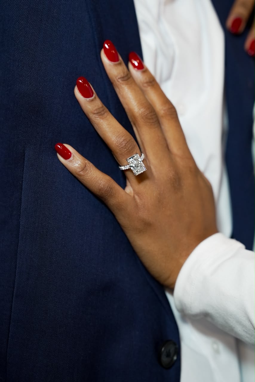 Otobong's engagement ring on Harrison's navy suit