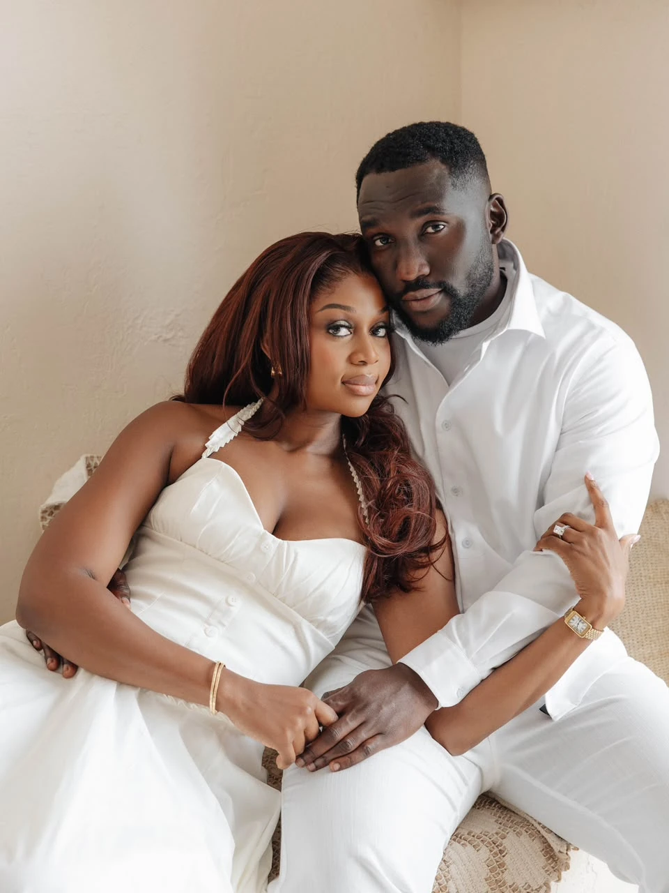 Harrison in white, holding Otobong close